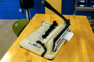 paper cutter cutting a three quarter inch stack of paper