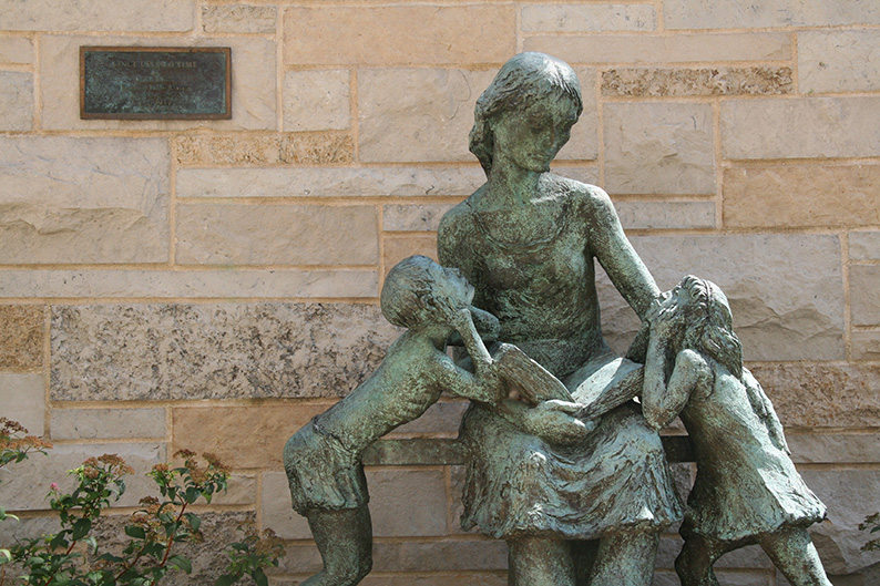 Once Upon a Time Sculpture of mother reading to two children